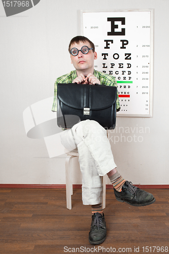 Image of person wearing spectacles in an office at the doctor