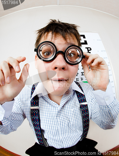 Image of person wearing spectacles in an office at the doctor