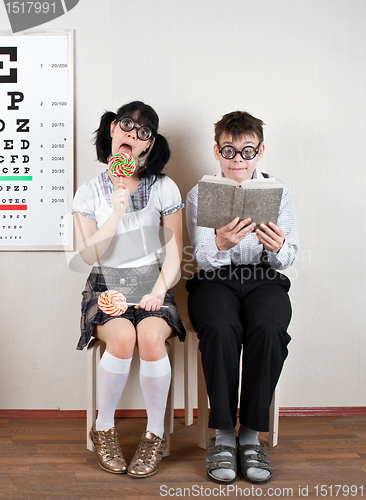 Image of Two person wearing spectacles in an office at the doctor