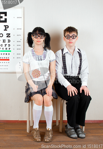 Image of Two person wearing spectacles in an office at the doctor