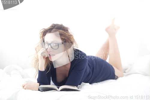 Image of woman in bed flirting