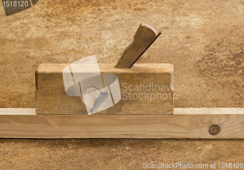 Image of planer on wood in brown background