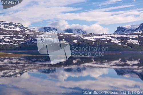 Image of Snowy mountains by lake