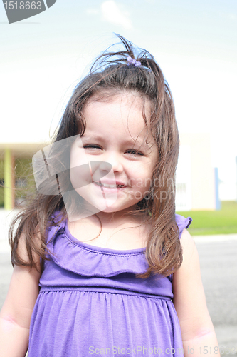 Image of cute little girl smiling in a park close-up 
