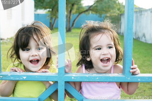 Image of Portrait of happy two sisters outdoors having fun