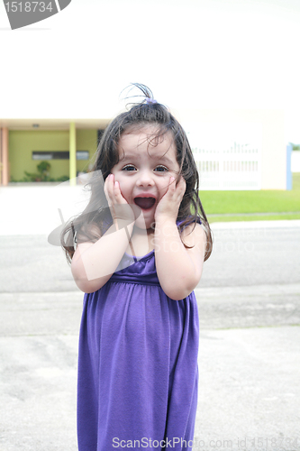 Image of Two years old girl expressing surprise outdoors