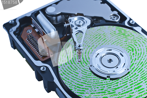 Image of open hard drive with green fingerprint on platter