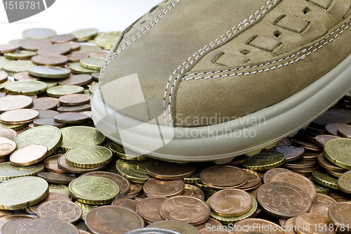 Image of leasure leather shoe walking on money