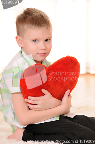 Image of child with a plush heart