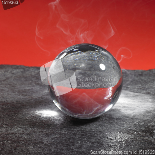 Image of crystal ball on stone surface