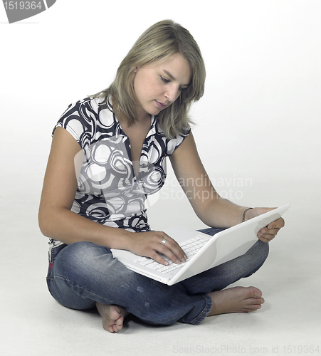Image of concentrated blonde girl working with a laptop