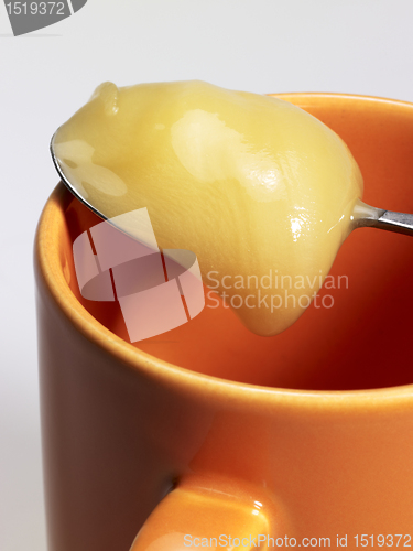 Image of cup and honey spoon