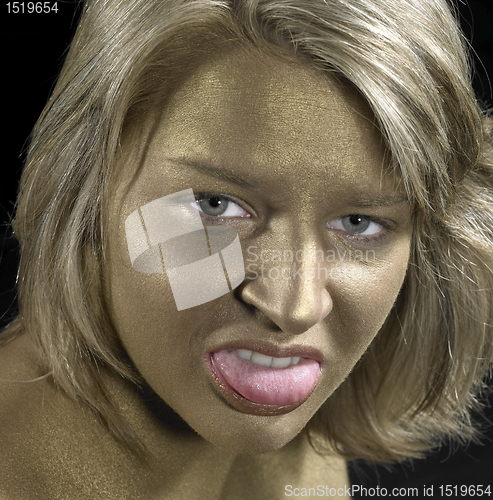 Image of angry woman with golden face