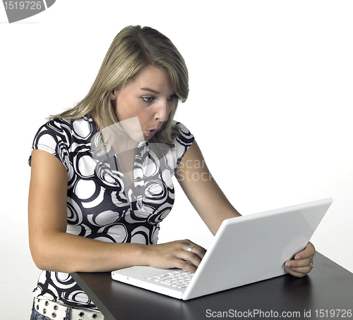 Image of amazed blonde computing girl