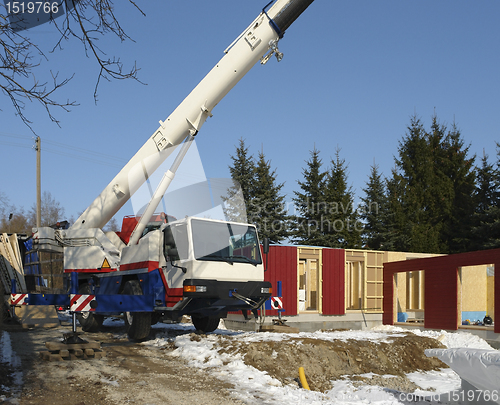 Image of wooden house construction at winter time