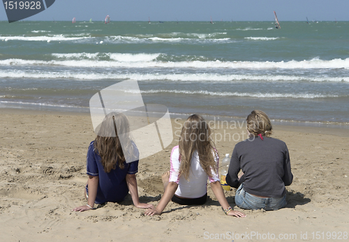 Image of three kids at the sunny beach