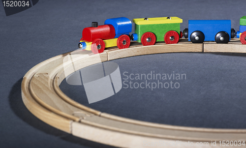 Image of colorful wooden toy train on tracks