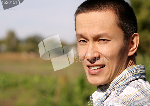Image of man looking at camera outdoors