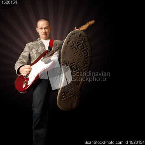 Image of rocker with guitar and foot