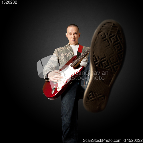 Image of rocker with guitar and foot