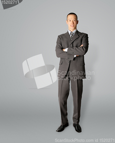 Image of smiling standing businessman in suit 