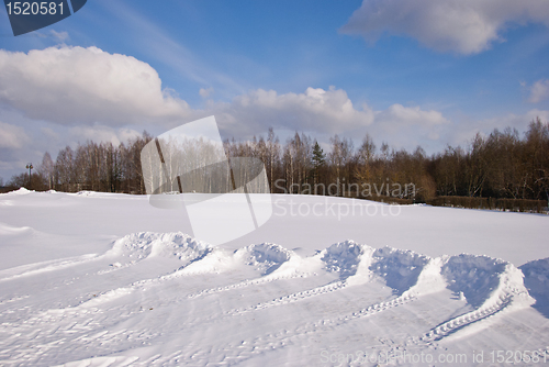 Image of Snow pushed into piles in the park winter backdrop 