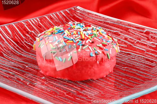 Image of Pink glazed muffin with sprinkles