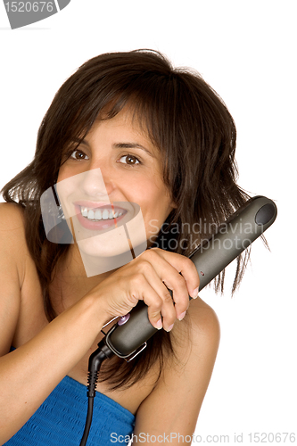 Image of woman using hair straighteners