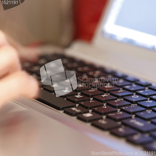 Image of Young woman working on laptop