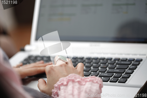 Image of Young woman working on laptop