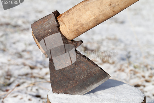 Image of Axe in stump. Close-up view