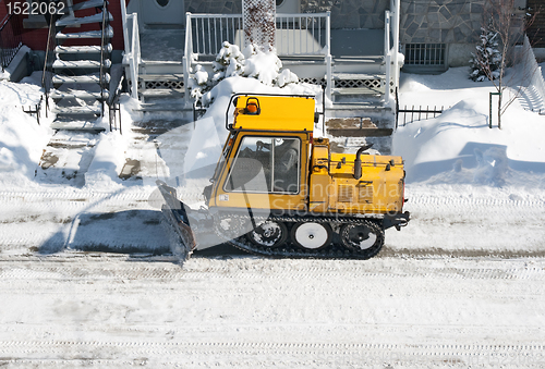 Image of City street cleaned from snow by a snowplough