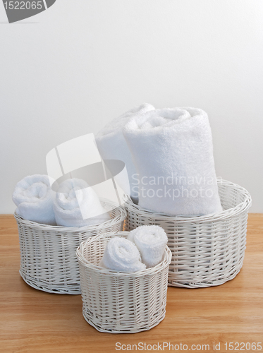 Image of Clean towels in white wicker baskets