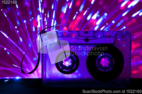 Image of Transparent Cassette tape and disco light background