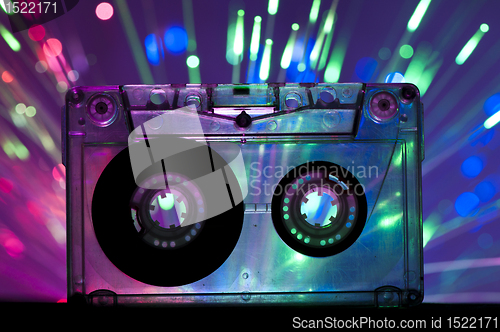 Image of Transparent Cassette tape and disco light background