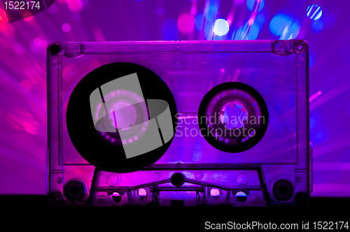 Image of Transparent Cassette tape and disco light background