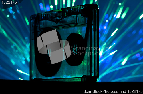 Image of Transparent Cassette tape and disco light background