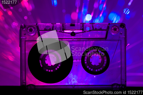 Image of Transparent Cassette tape and disco light background
