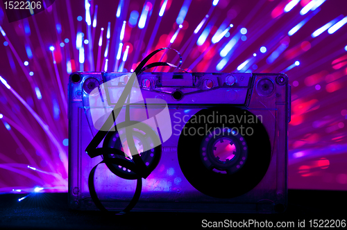 Image of Transparent Cassette tape and disco light background