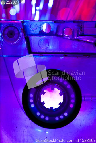 Image of Transparent Cassette tape and disco light background