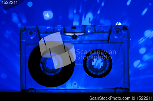Image of Transparent Cassette tape and disco light background