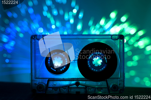 Image of Transparent Cassette tape and disco light background