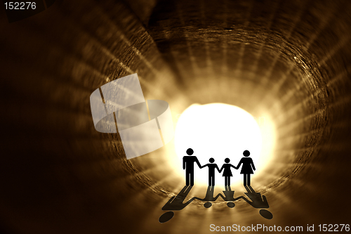 Image of In to the light. Family silhouette inside the rolled paper