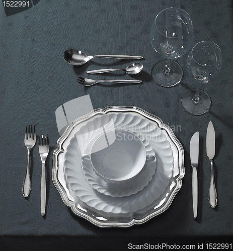 Image of noble place setting on dark tablecloth