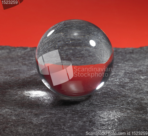 Image of crystal ball on stone surface