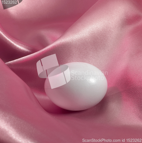 Image of egg in pink satin fabrics