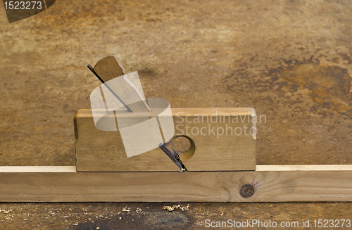 Image of planer on wooden plank