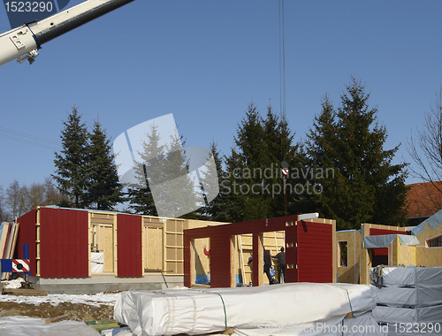 Image of wooden house construction in sunny ambiance