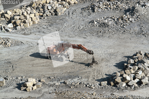 Image of resting quarry digger and stones