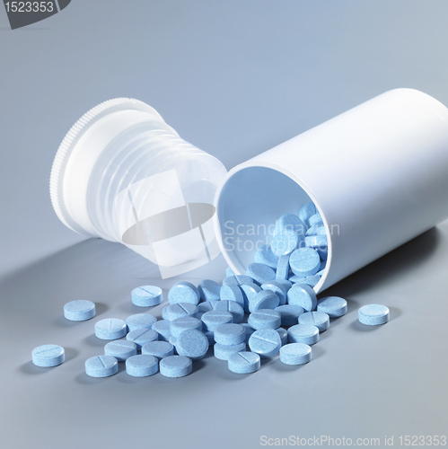 Image of blue pills and can